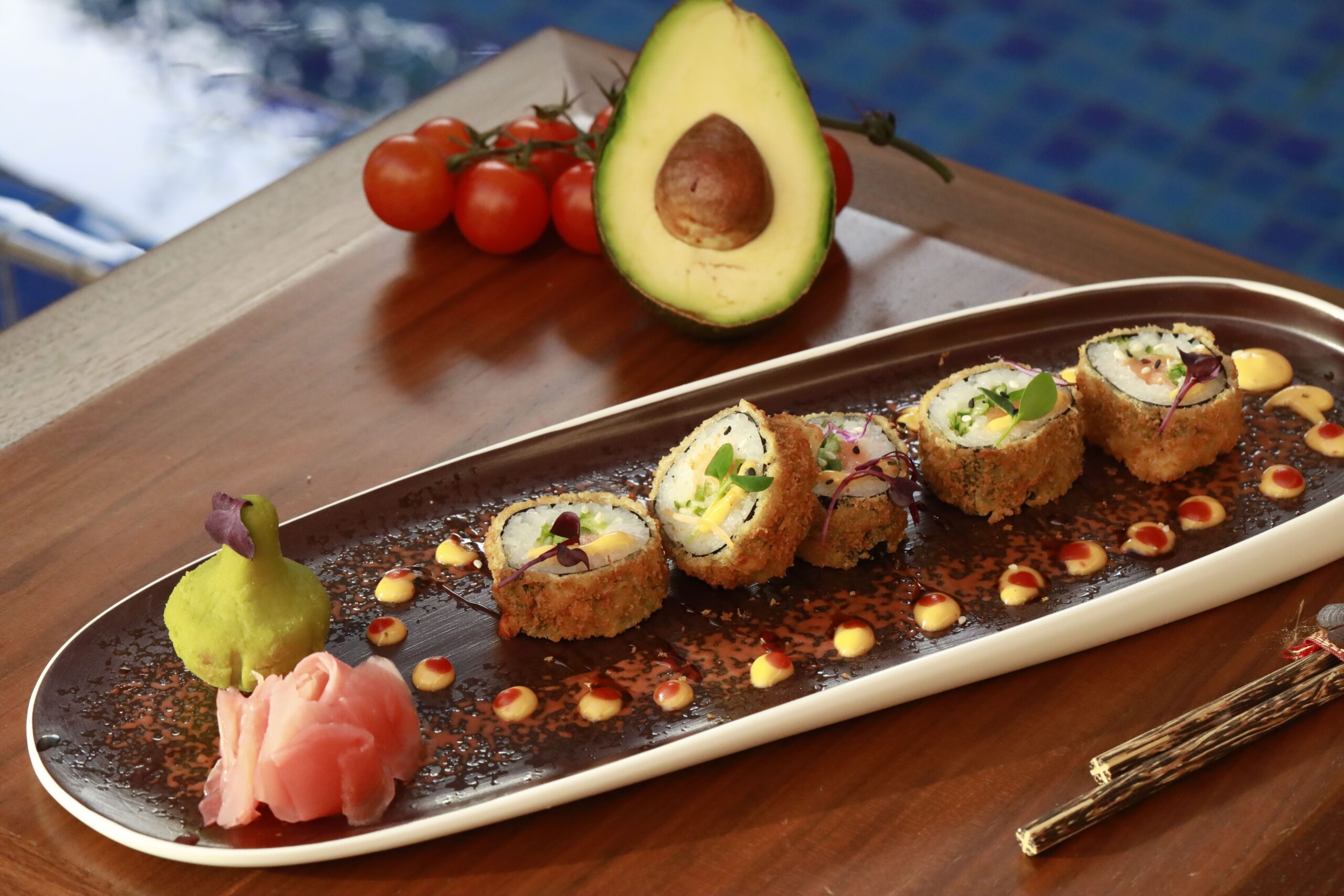 Crispy sushi rolls artfully plated with avocado, bali