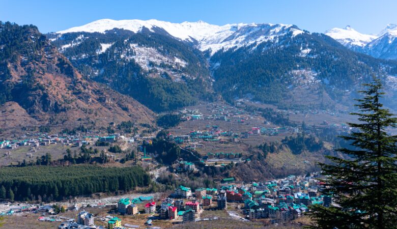 Manali nestled in the Himalayan mountains under a clear blue sky