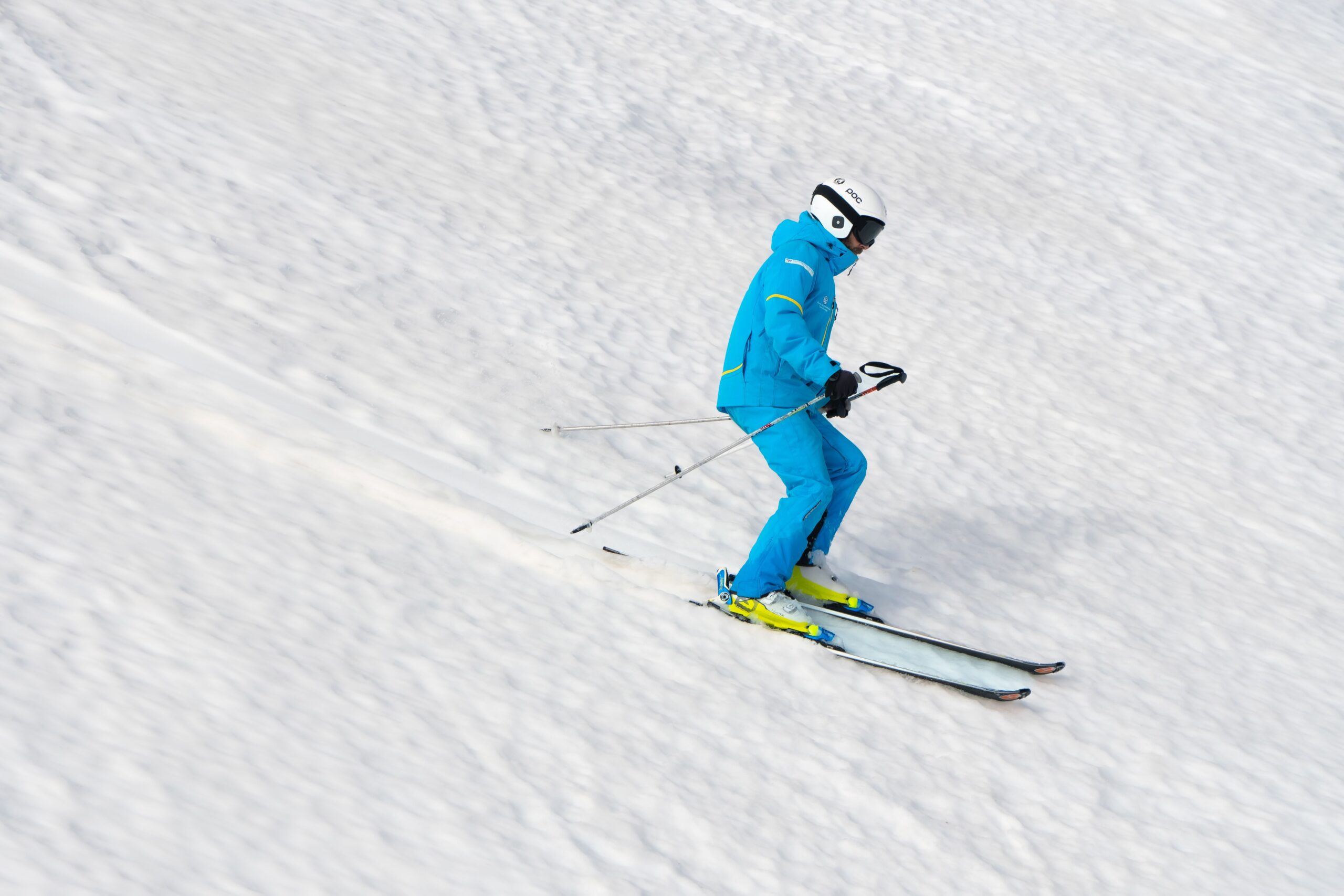 skiing downhill on a snowy slope during winter,