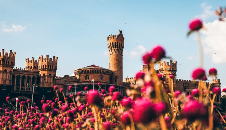 Bangalore Palace with vibrant pink flowers